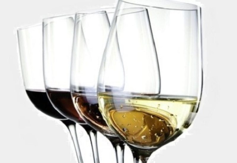 Four wineglasses with different colors of wine