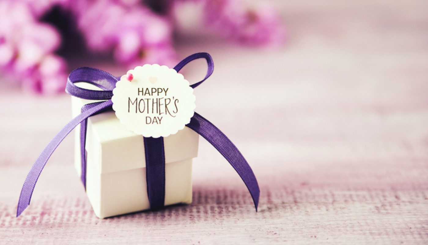 Mother's Day gift box with purple ribbon and wisteria bouquet