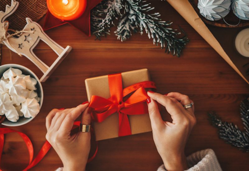 Woman wrapping Christmas gifts, overhead shot