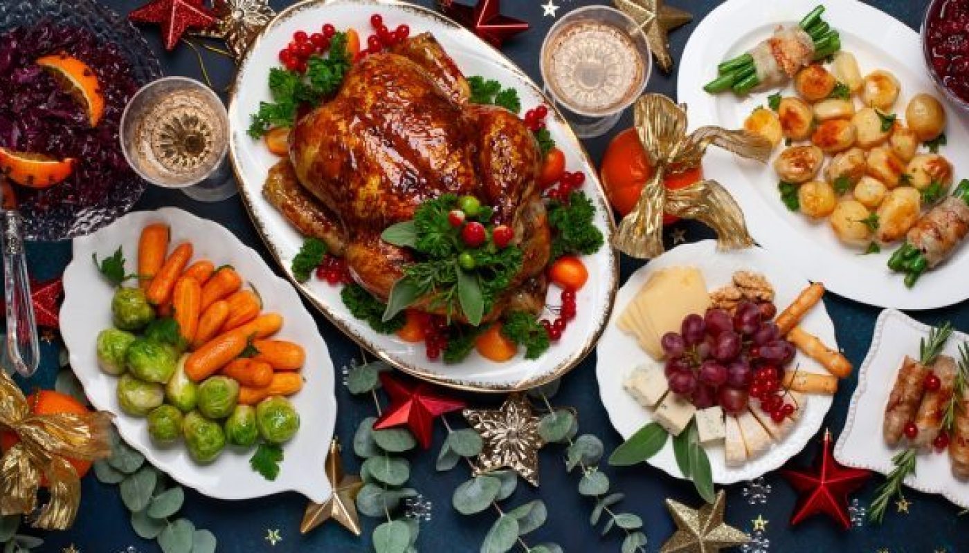 Concept of Christmas or New Year dinner with roasted chicken and various vegetables dishes.
