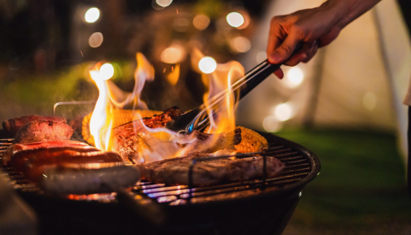 Family making barbecue in dinner party camping at night