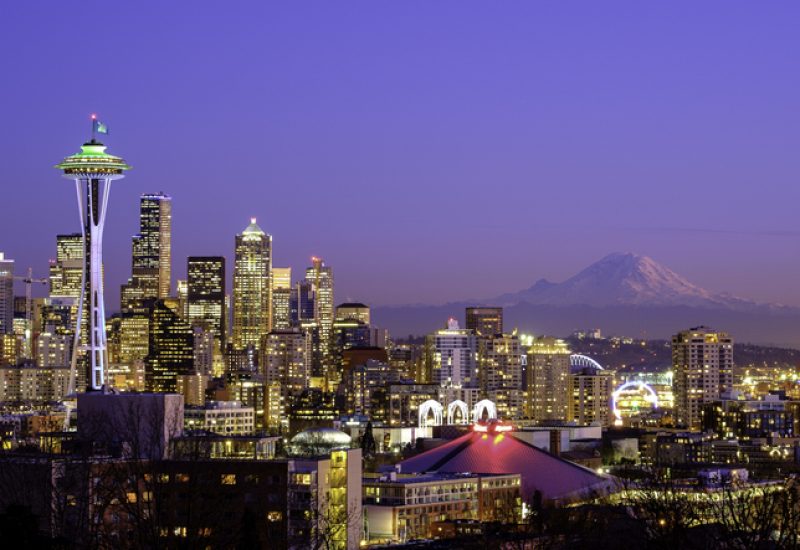 Seattle skyline at night with Mt Rainier in the distance