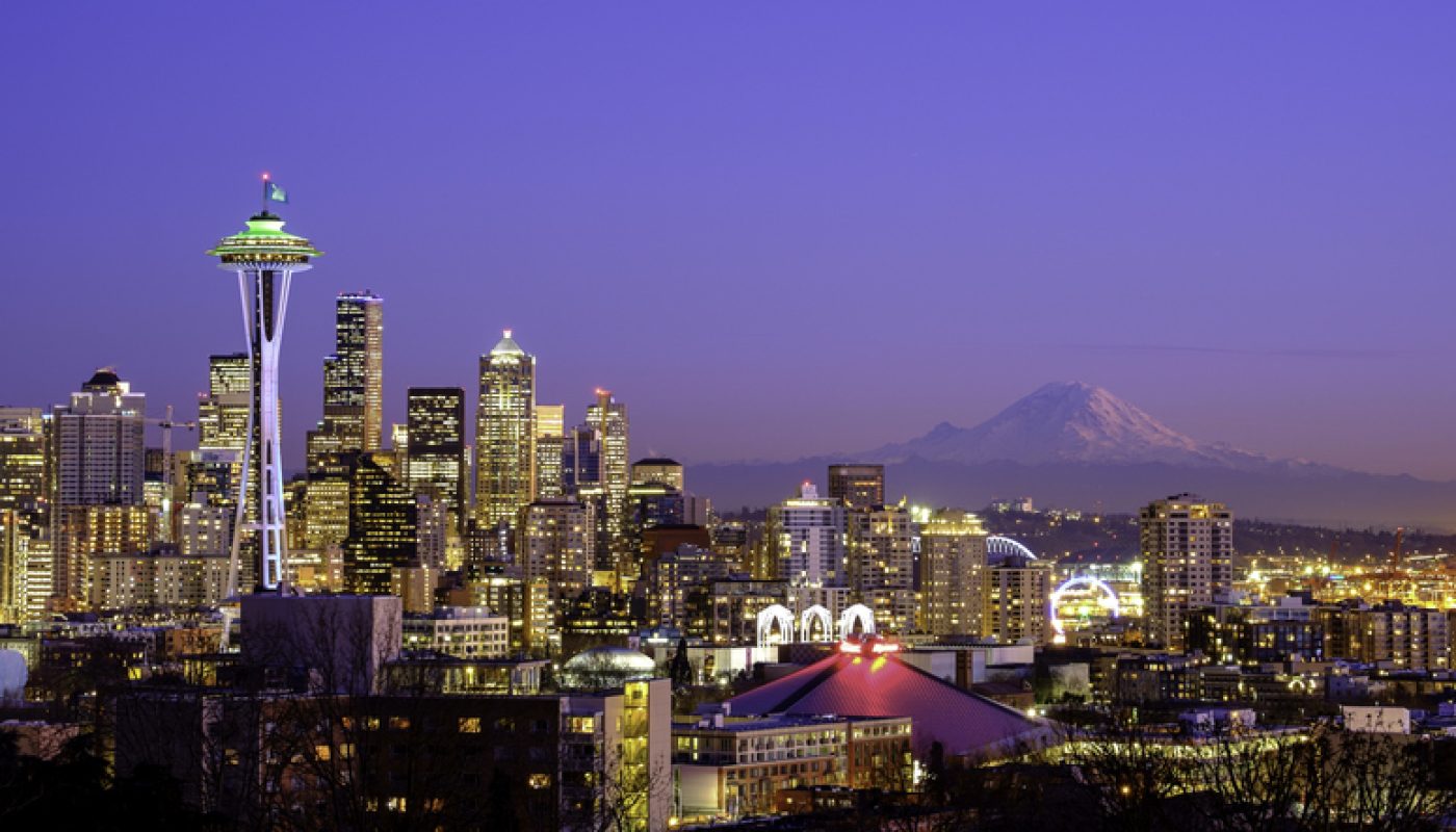 Seattle skyline at night with Mt Rainier in the distance