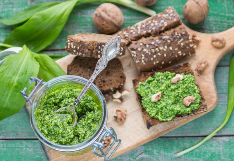Ramson, wild garlic and sauce pesto on a wooden table