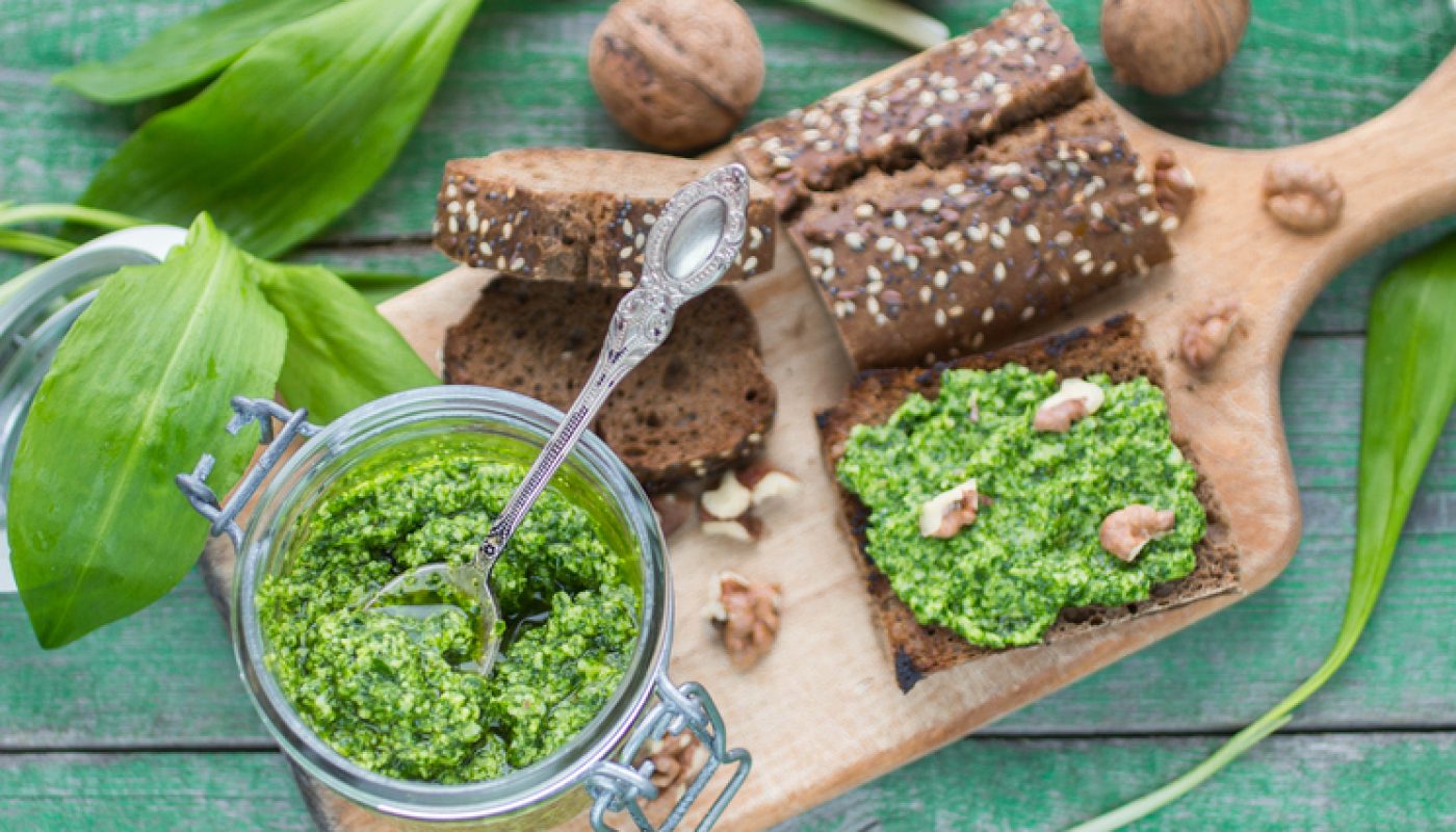Ramson, wild garlic and sauce pesto on a wooden table