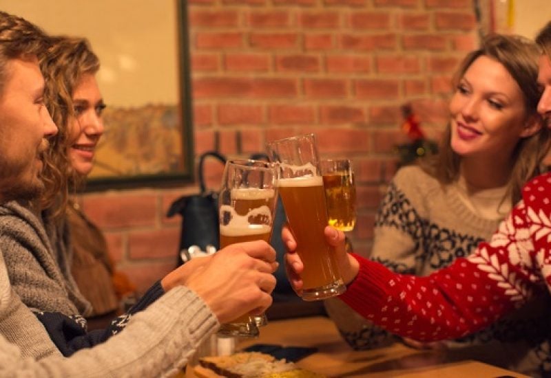 Friends having beers in restaurant.
