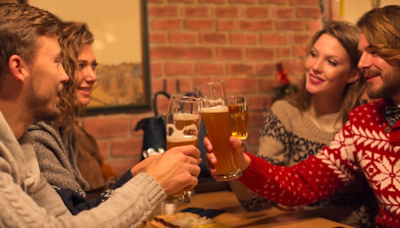 Friends having beers in restaurant.