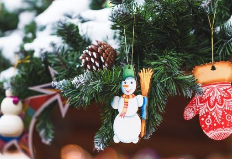 Little toy snowman in the decorations for the New Year