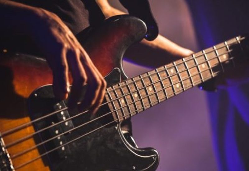 Close-up photo of bass guitar player
