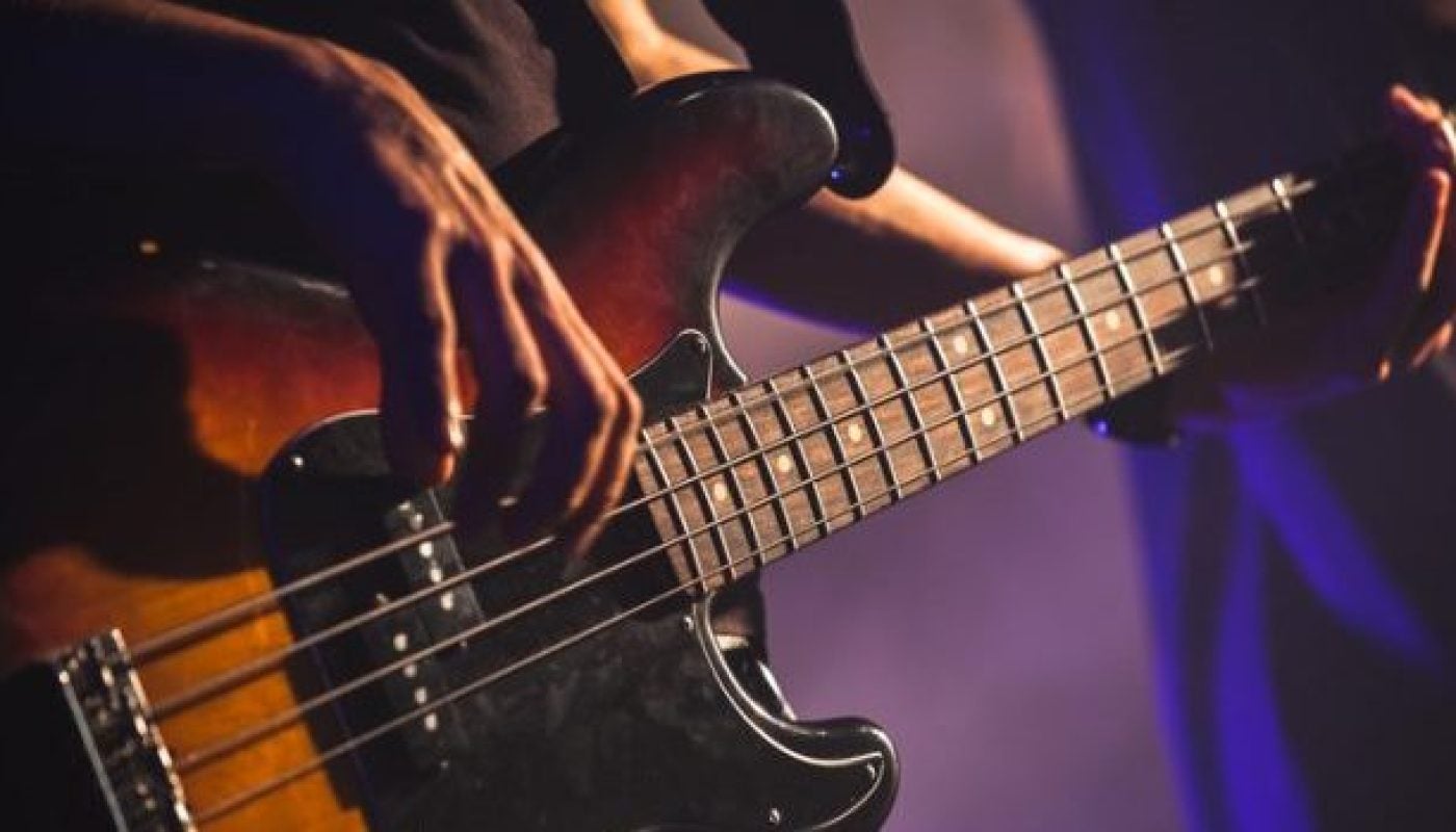 Close-up photo of bass guitar player