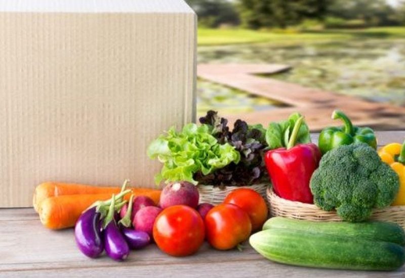 Food Delivery service: Vegetable delivery at home online order for cooking and packages box with blank for text. on wooden table background.