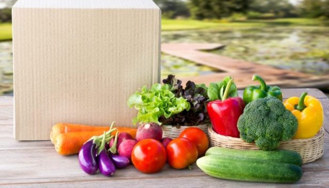 Food Delivery service: Vegetable delivery at home online order for cooking and packages box with blank for text. on wooden table background.